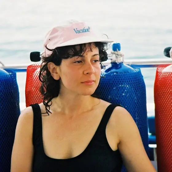 Client ad: a woman in a cap by the sea