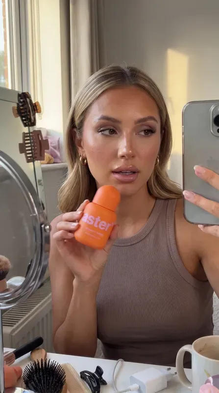 Video still: a creator with aster* serum at a mirror