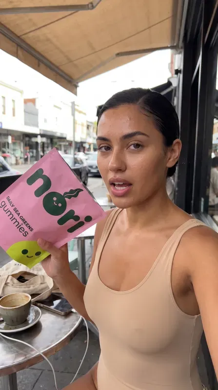 nori ad, story: a creator holding the pouch outside a cafe