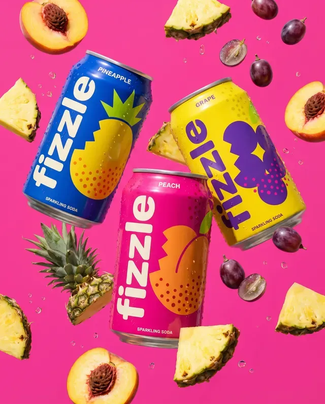 Fizzle ad: three cans with fruit on pink
