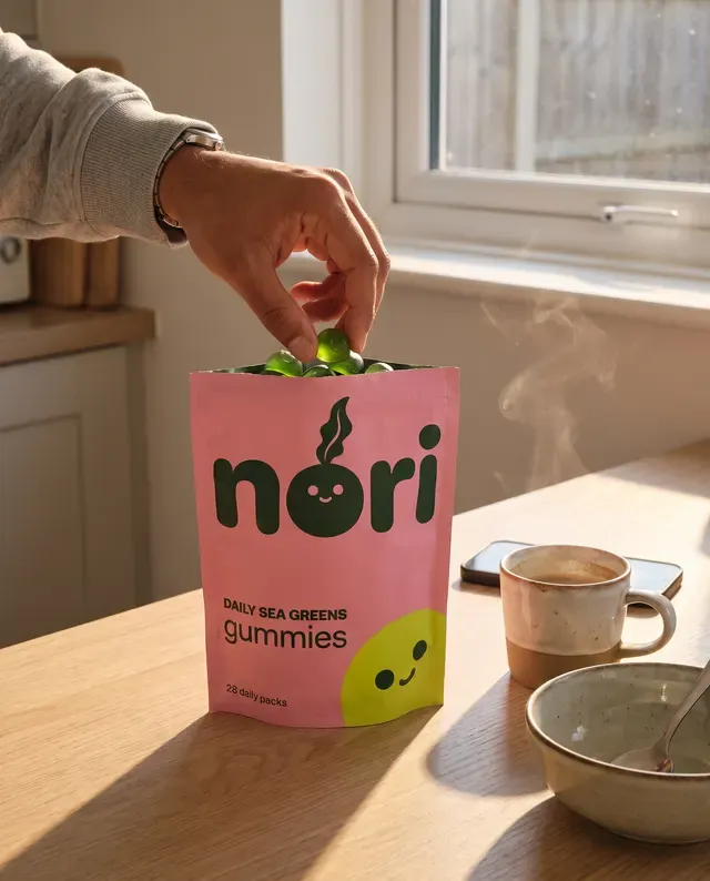 nori ad: a hand taking a gummy from the pouch at breakfast